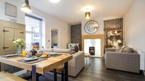 a living room with a table and a couch at The Hadrian Apartment in Hexham