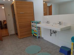 a bathroom with a sink and a mirror at Der Perweinhof in Donnersbachwald +159 photos