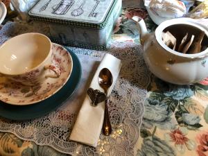 a table with a cup of tea and a spoon at L'Ape Regina in Ferrara
