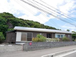 a small house on the side of a road at Lulumalu AMAMI in Amami