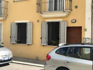a car parked in front of a building with windows at Casavacanze estate 3 in San Benedetto del Tronto