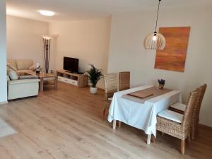 a living room with a white table and chairs and a couch at Wanderglück Rotenfels in Traisen