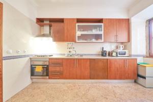 a kitchen with wooden cabinets and a sink at Charming Apartment in Alfama with River View in Lisbon