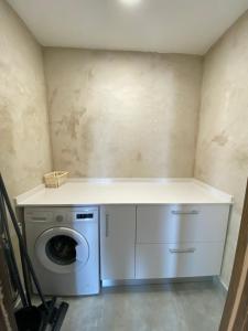 a laundry room with a washing machine and a counter at Casa Clotilde in Alcañiz