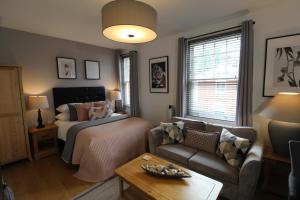 a living room with a bed and a couch at The Larches in Wolverhampton