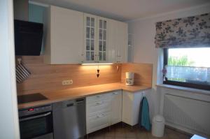 a kitchen with a wooden counter top and a window at Ferienwohnung Biedermann in Schönwald