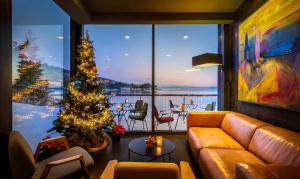 a living room with a christmas tree and a large window at Boutique & Design Hotel Navis - Small Luxury Hotels of the World in Opatija