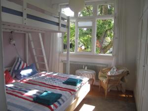 a bedroom with a bunk bed and a ladder at Apartment am Birnbaum in Reutlingen
