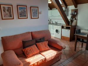 a living room with a couch and a kitchen at CASA GRACIANO I in Ochagavía