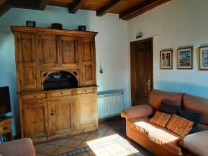 a living room with a wooden cabinet and a couch at CASA GRACIANO I in Ochagavía