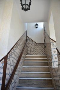 a set of stairs with a chandelier at Residencial A Doca in Faro