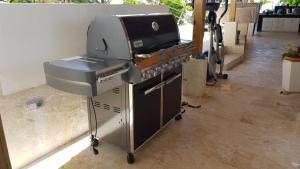 a grill sitting in a room next to at casaenjoysamana in Los Naranjos
