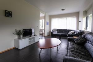 a living room with a couch and a coffee table at Guesthouse Dalbaer in Fludir