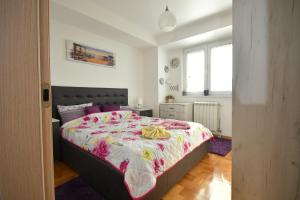 um quarto com uma cama grande e uma colcha colorida em Modern & Luxury em Skopje
