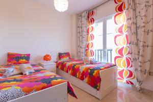 a bedroom with two beds and a window at Residencial Duquesa 18 in Manilva +23 photos