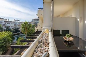 a balcony of a building with some plants on it at Residencial Duquesa 18 in Manilva