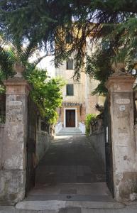an entrance to a building with a gate and trees at B&B IL CEDRO in Cava deʼ Tirreni