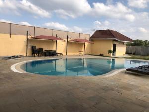 a large swimming pool in a yard with a building at Mara Frontier Hotel in Narok