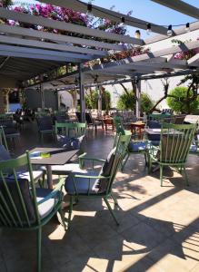 a group of chairs and tables on a patio at Ipanema Hotel in Tigaki