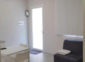 a room with a chair and a desk and a mirror at Casa Maria in Modica