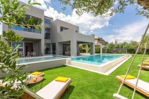 a villa with a swimming pool and a yard with swings at Sissy Luxury Villa Chania in Platanias