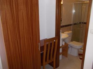 a bathroom with a toilet and a sink at Basic Hotel in Mindelo