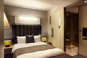 Postel nebo postele na pokoji v ubytování Best Louis Hamilton Hotel Haeundae