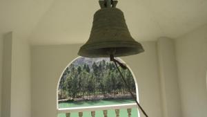 a lamp with a bell on top of a window at Guizado Portillo Hacienda & Resort in Lunahuaná