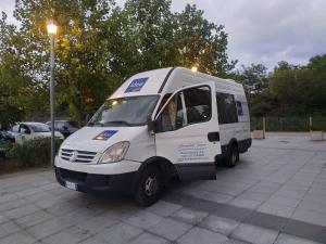 a small white van parked in a parking lot at Idea Hotel Milano Malpensa Airport in Case Nuove
