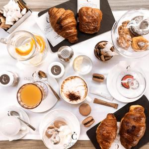 a table with various types of pastries and coffee at B&B IL CEDRO in Cava deʼ Tirreni