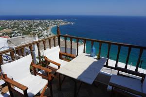 a table and chairs on a balcony overlooking the ocean at House in Skyros with an amazing sea view in Skiros