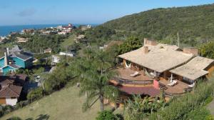 an aerial view of a house on a hill at Luxury Suites Vila Indonésia in Garopaba