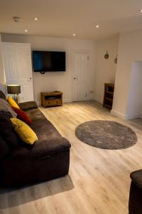 a living room with a couch and a rug at Sandy bottoms in Llandudno