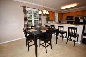 a dining room with a black table and chairs at 1515 Willow Bend Condo in North Myrtle Beach