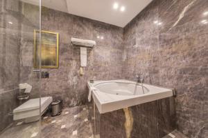 a bathroom with a sink and a shower at Al Masa Hotel Nasr City in Cairo