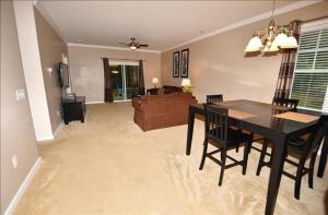 a dining room and living room with a black table and chairs at 1515 Willow Bend Condo in North Myrtle Beach