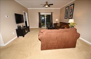 a living room with a couch and a flat screen tv at 1515 Willow Bend Condo in North Myrtle Beach