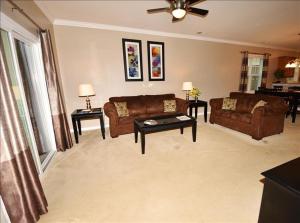 a living room with two couches and a ceiling fan at 1515 Willow Bend Condo in North Myrtle Beach