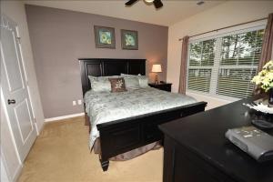 a bedroom with a bed and a desk and a window at 1515 Willow Bend Condo in North Myrtle Beach +7 photos