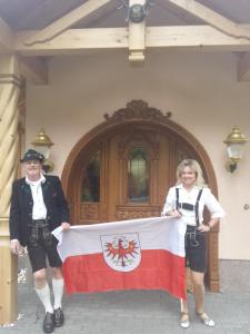 a man and a woman holding a flag at Haus Bergblick in Prägraten