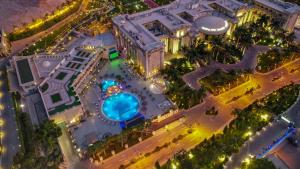 an overhead view of a building with a swimming pool at night at Al Masa Hotel Nasr City in Cairo