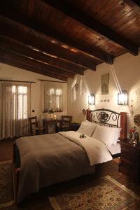 a bedroom with a large bed and a dining room at Chateaux Constantin Agistro in Ángistron