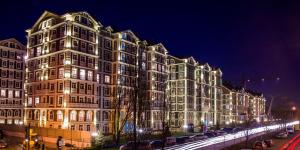 a large building is lit up at night at Royal House Apartment in Kyiv