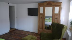 a room with a mirror and a chair and a bed at Schlössje in Lieser