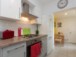 a kitchen with a stove and a refrigerator at TownHouse @ West Avenue Crewe in Crewe