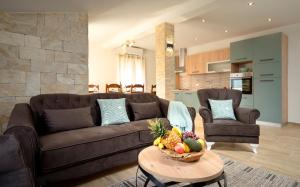 a living room with a couch and a table with a bowl of fruit at Villa Vista Hvar in Jelsa