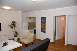 a living room with a couch and a table at Petit Apart Villa Regina in Villa Regina