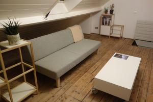 a living room with a couch and a table at Studio Minerva in Antwerp