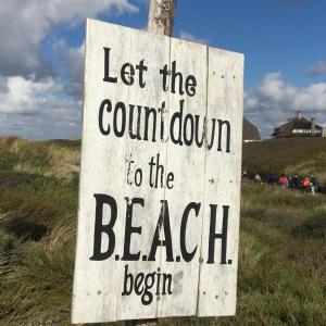 a sign that reads let the countdown to the beach begin at ZeeBedStay in Noordwijk aan Zee