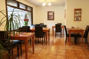 a dining room with wooden tables and chairs at Ewenny Farm Guest House in Bridgend